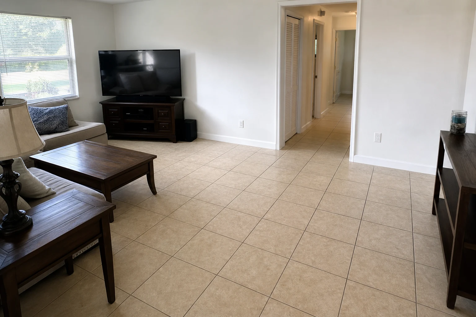 Before luxury vinyl plank flooring installation in Rockledge FL family room with ceramic tile